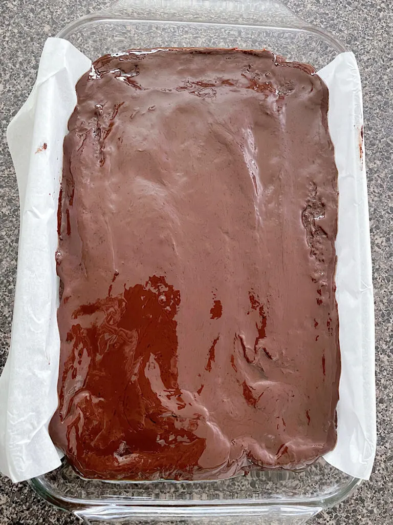 A pan of brownies covered in chocolate ganache.