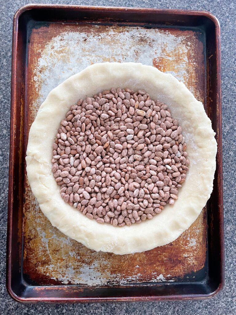 Dried beans in an unbaked pie crust.