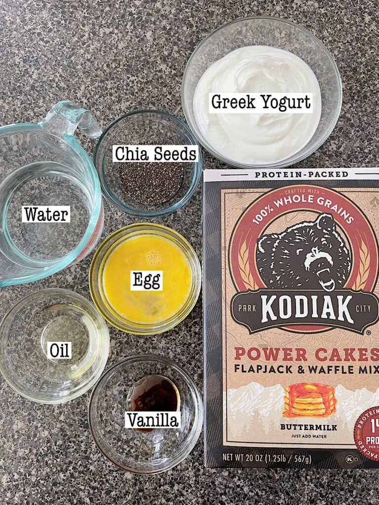 Ingredients for Kodiak Protein Waffles including Kodiak Power Cakes Mix, greek yogurt, chia seeds, water, egg, oil, and vanilla.