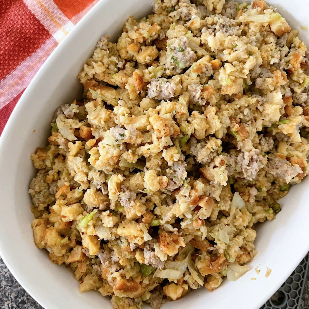 Thanksgiving Stove Top Stuffing with sausage in a white baking dish.