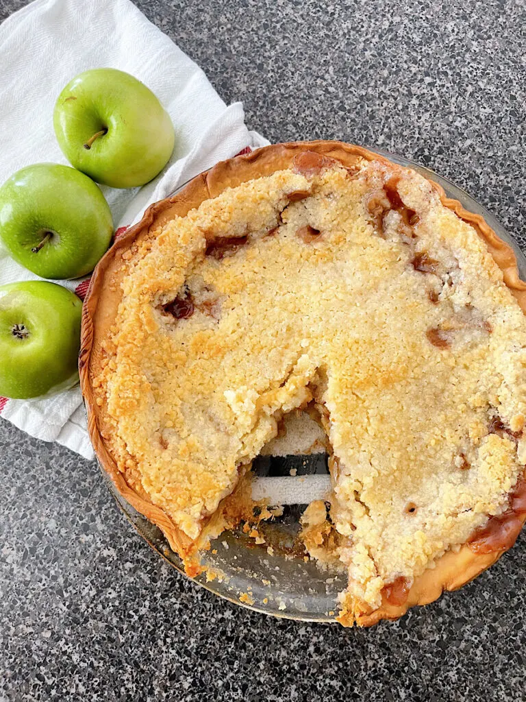 An award winning apple pie missing one slice.