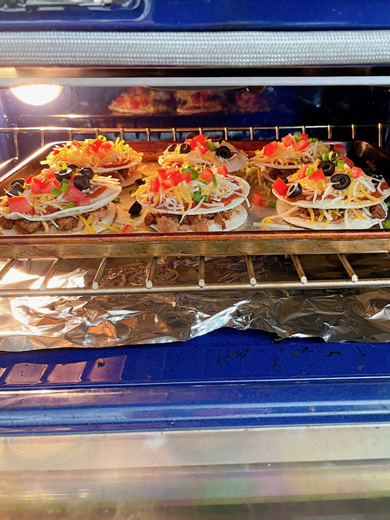 Homemade Mexican Pizzas on a baking sheet in the oven.