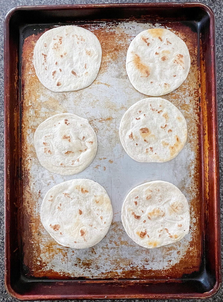 Tortillas on a baking sheet.