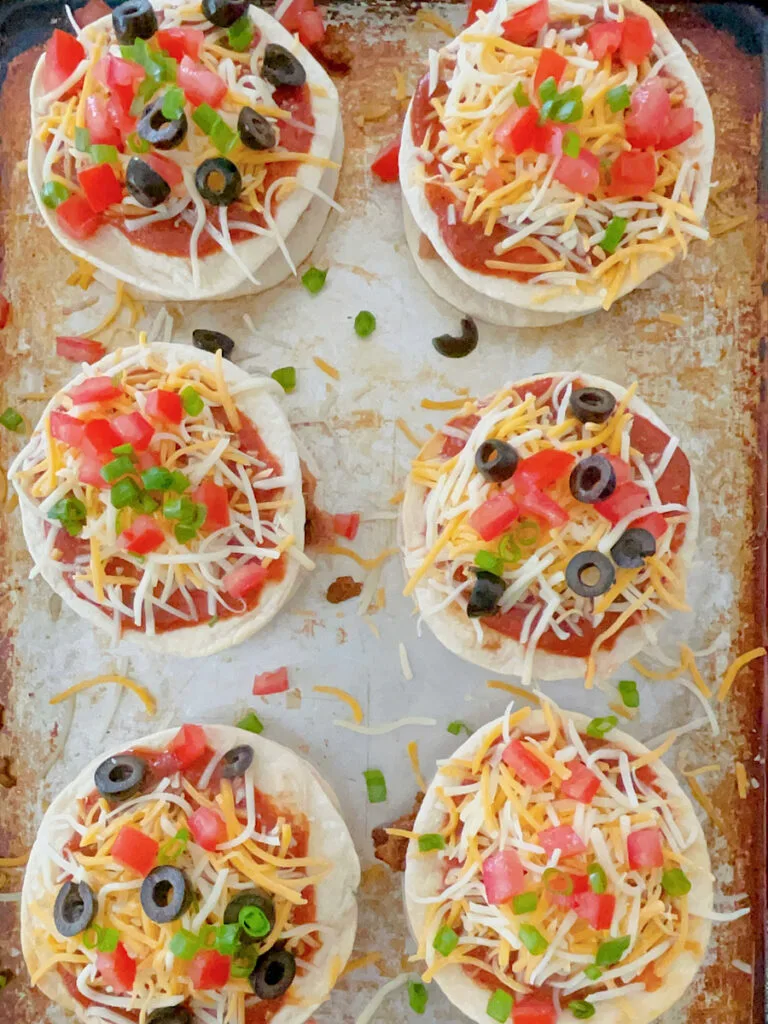 A homemade Taco Bell Mexican Pizza topped with black olives.