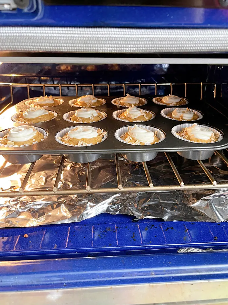 Starbucks pumpkin muffins baking in an oven.
