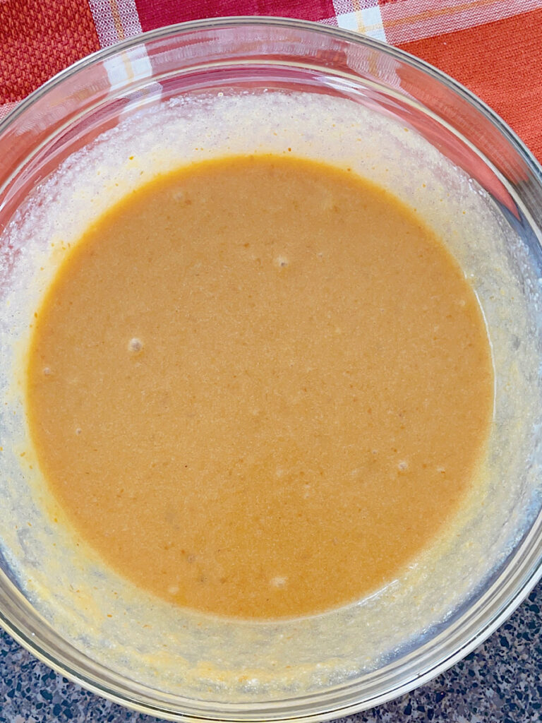 Wet ingredients in a bowl for pumpkin muffins.