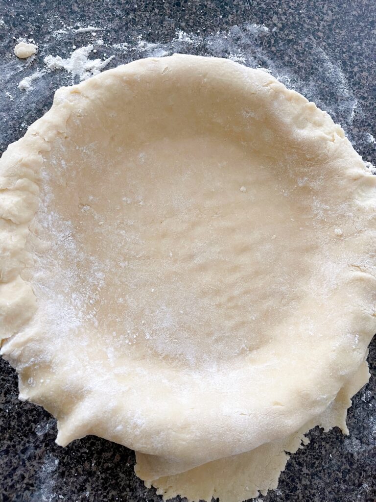 An unbaked pie crust in a pie plate.