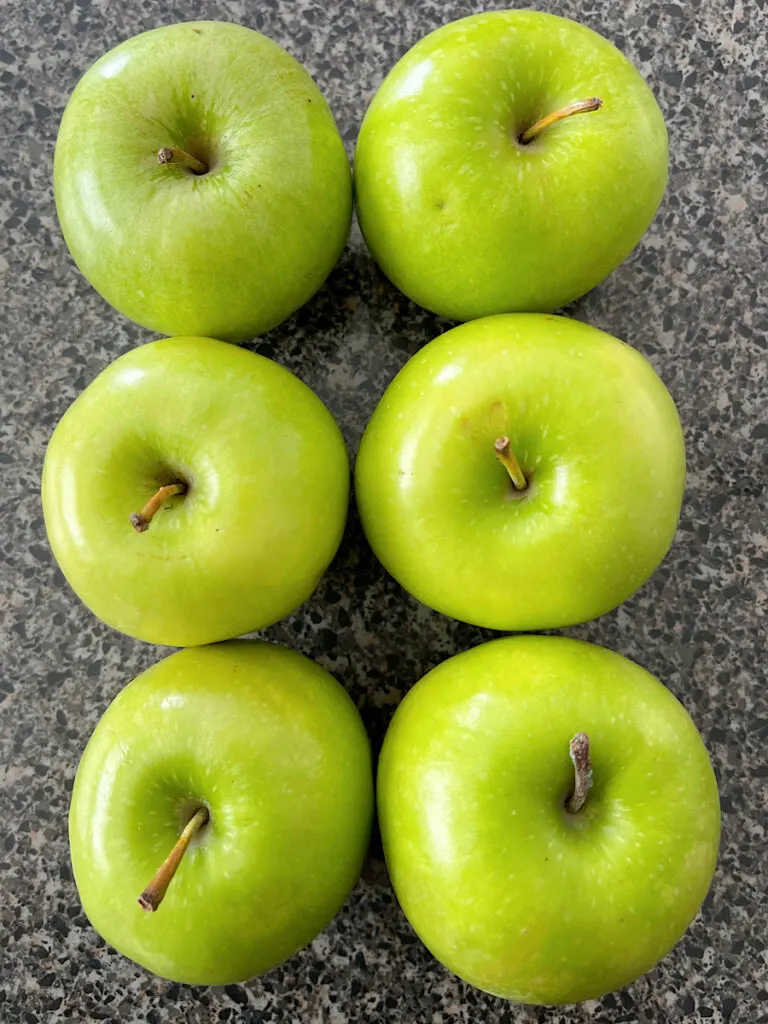 Six green granny Smith apples.