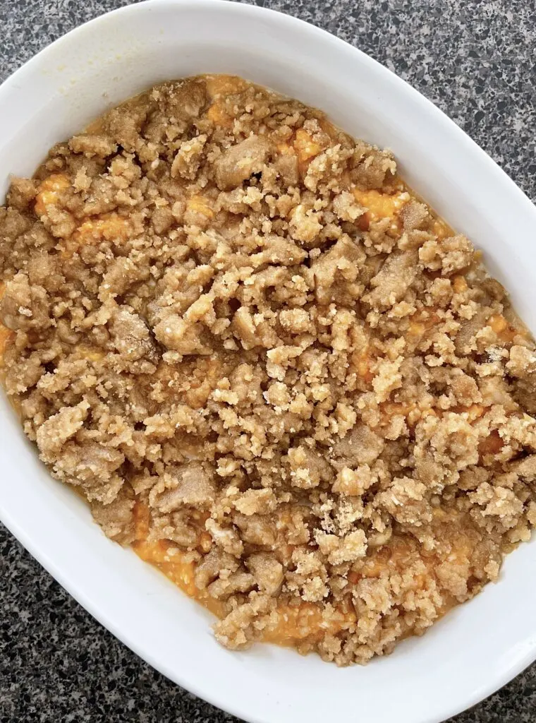 A dish of mashed yams topped with streusel.