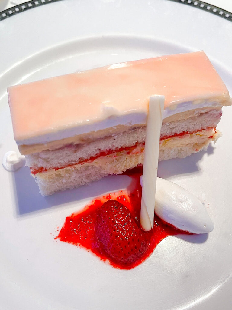 Celebration Cake: layers of cheesecake covered with strawberries, and embedded in rich vanilla cream.