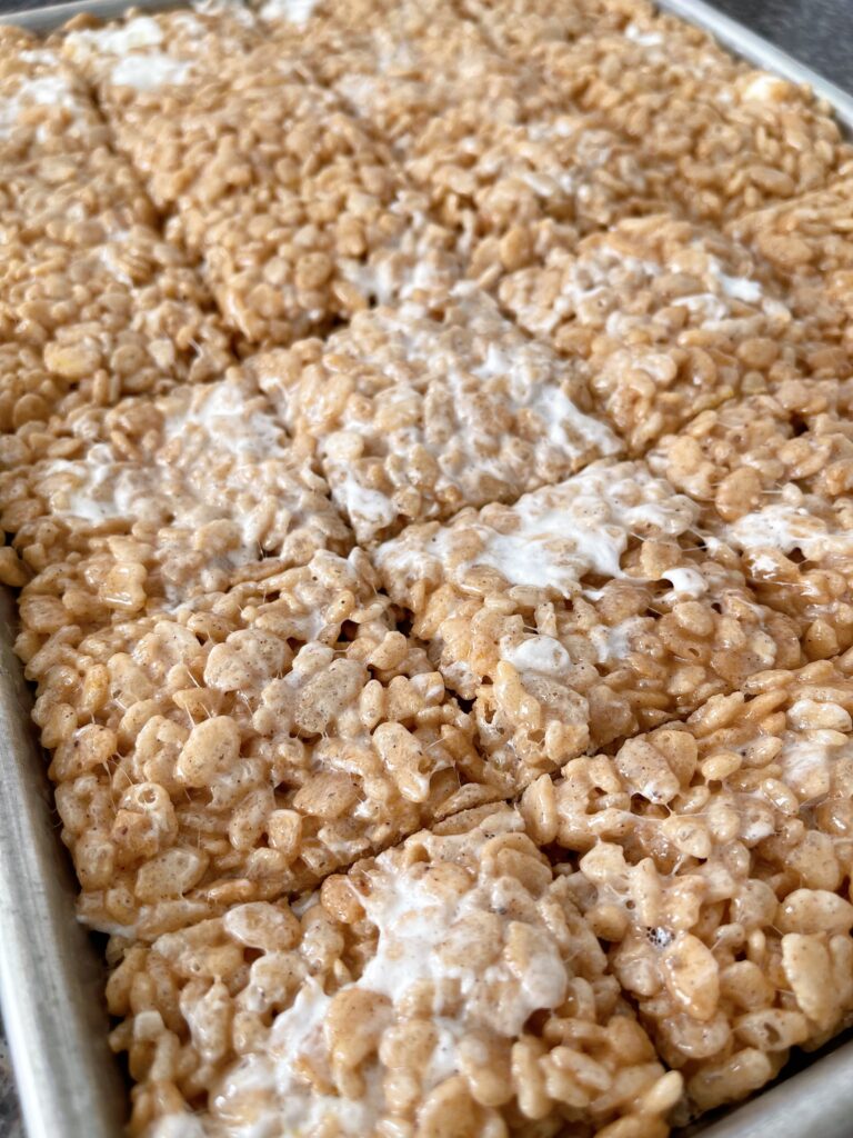 Rice Krispies mixed with melted marshmallow mix pressed into a jelly roll pan.