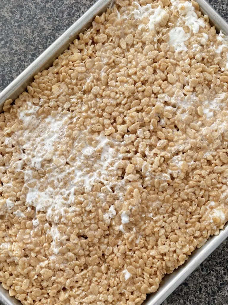 Rice Krispies mixed with melted marshmallow mix pressed into a jelly roll pan.