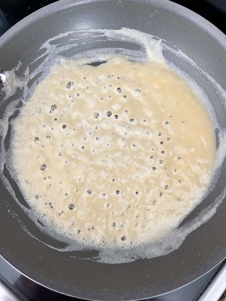 Flour and butter mixed together in a sauce pan to make a roux for turkey gravy.