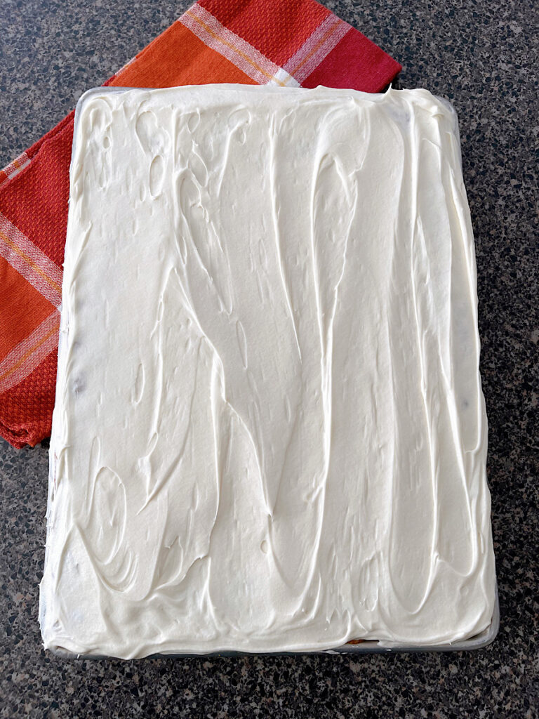 A pan of pumpkin bars with cream cheese frosting.