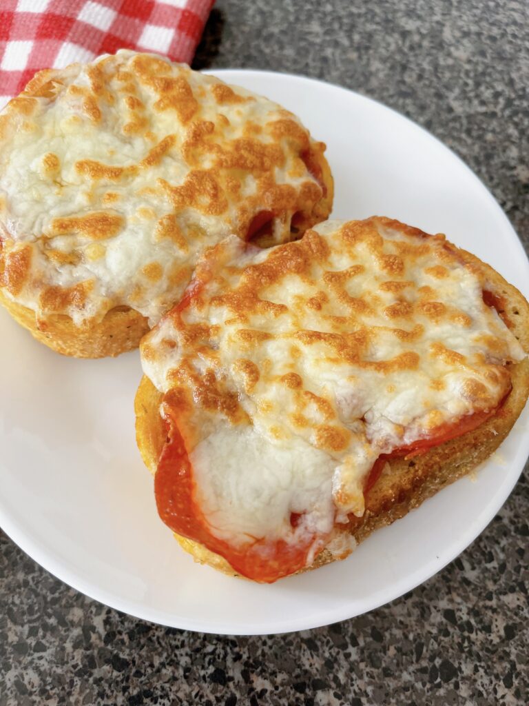 Two slices of Texas garlic toast topped with pizza sauce, pepperoni, and melted mozzarella cheese.