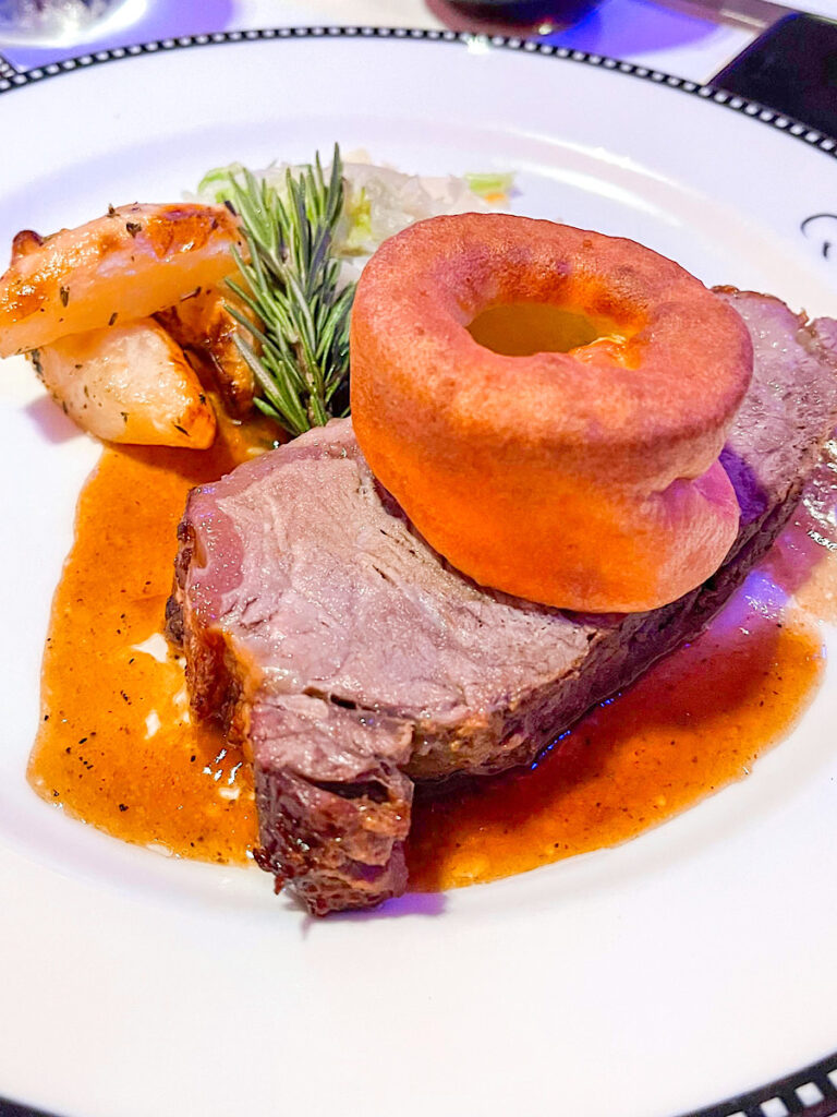 King George’s Roasted Privateer Strip Loin: With Thyme-Roasted Potatoes, Buttered Savoy Cabbage, Yorkshire Pudding and a Rosemary Wine Sauce from Pirate Night on the Disney Magic.