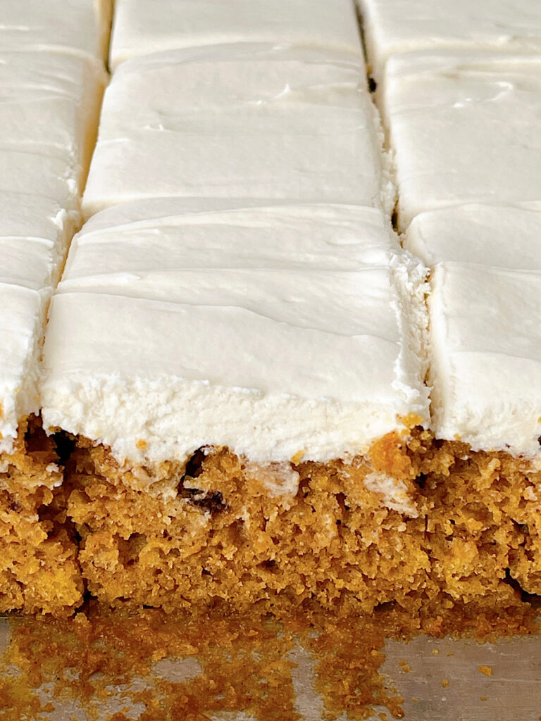 Pumpkin bars with cream cheese frosting cut into squares.