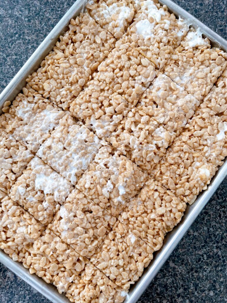 Rice Krispies mixed with melted marshmallow mix pressed into a jelly roll pan.