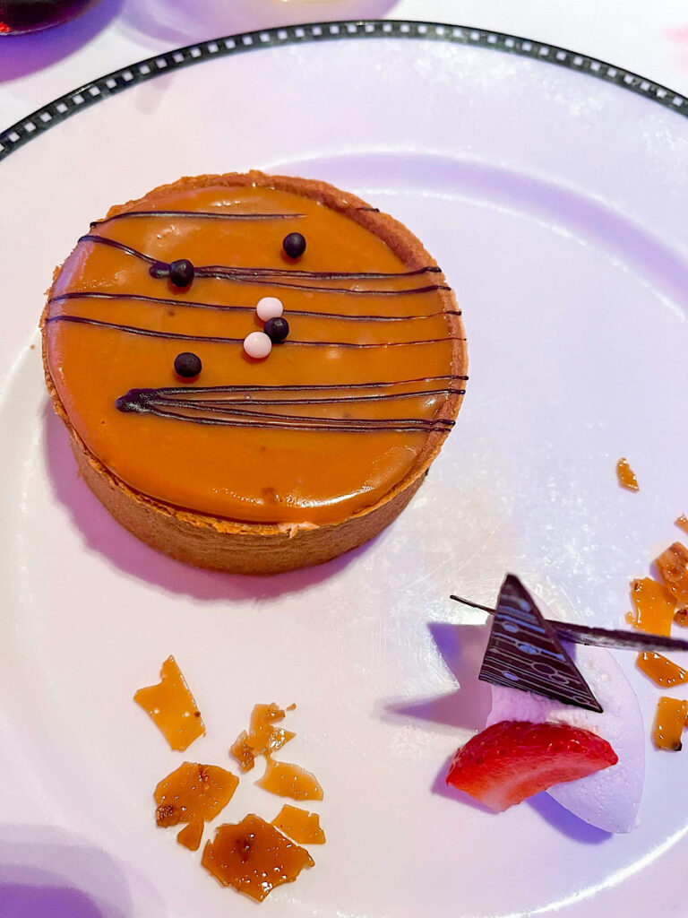 Caramel Macadamia Nut Cheesecake Tart: Served with Whipped Cream and Caramel Ganache from Pirate Night on the Disney Magic.