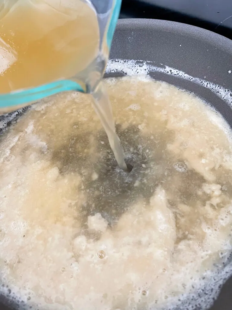 Turkey drippings added to a roux in a sauce pan to make gravy.