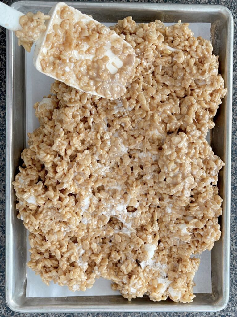 Rice Krispies mixed with melted marshmallow mix pressed into a jelly roll pan.