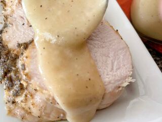 Turkey gravy spooned over a slice of turkey.