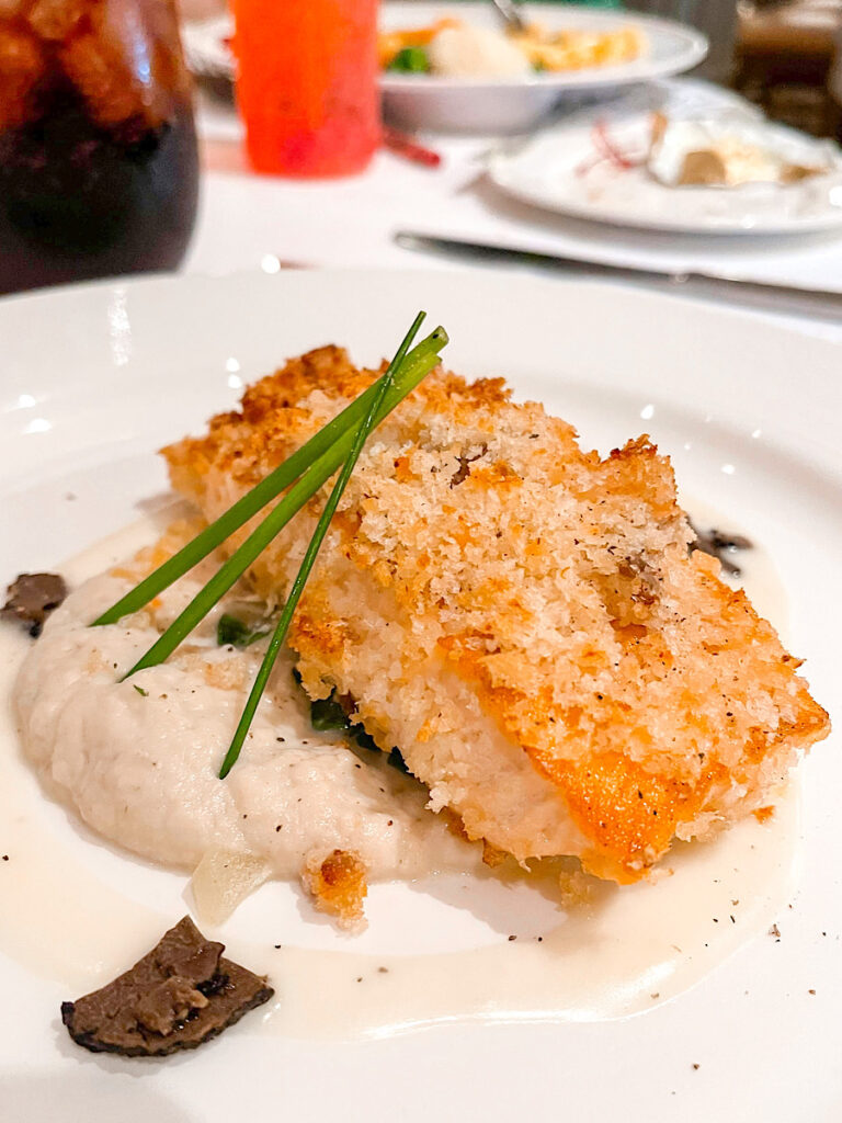 Oven-Baked Salmon Royale: Crowned with a King Smoked Salmon Horseradish Crust, accompanied by sauteed Swiss Chard, Truffled Cauliflower puree and white wine Beuree Blanc from Lumiere's on the Disney Magic.