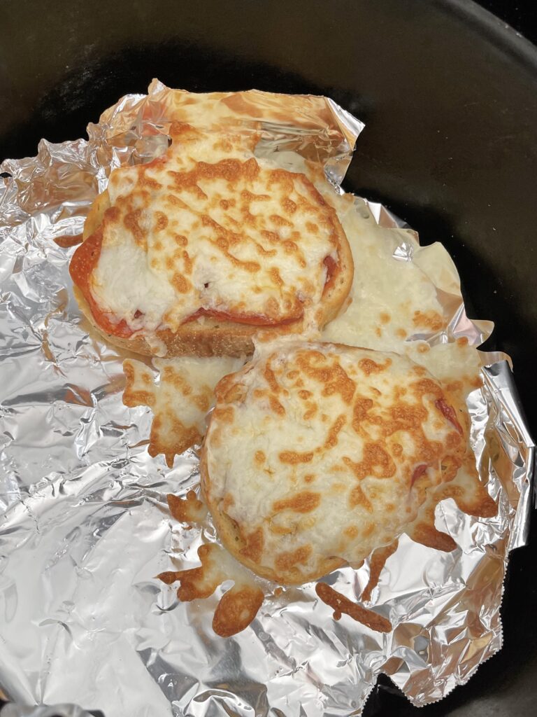 Two slices of Texas garlic toast topped with pizza sauce, pepperoni, and melted mozzarella cheese.