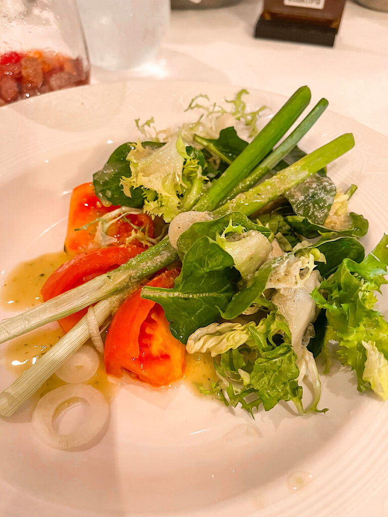 Beefsteak Tomato and Vidalia Onion Salad: with Baby Greens, Spring Onions, and a Cabernet Wine Vinaigrette from Lumiere's on the Disney Magic.