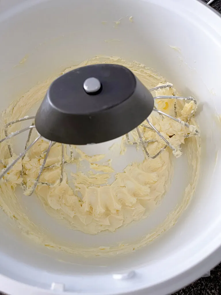 Butter and cream cheese in a stand mixer with a whisk attachment.