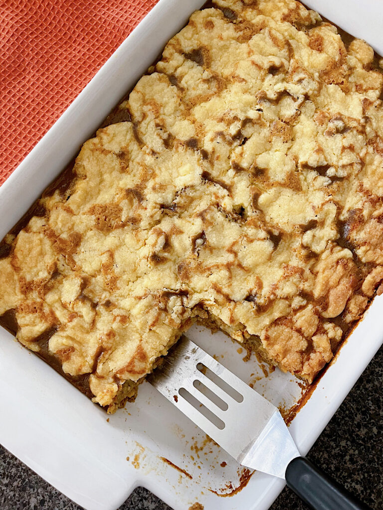 A cake mix pumpkin cobbler with one slice removed.