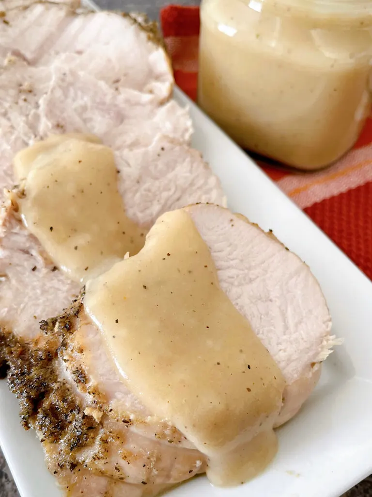 Turkey gravy spooned over a slice of turkey.