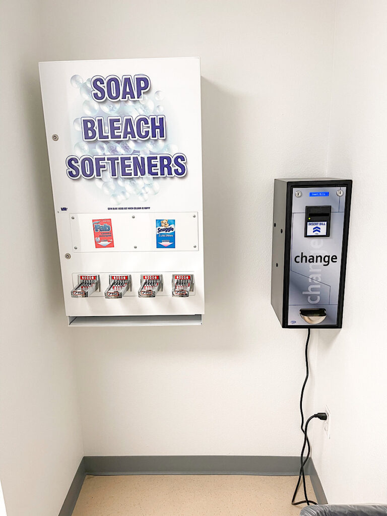 Soap dispenser and change machine in a laundry room at Kalahari Resort.