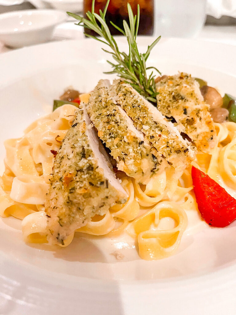 Fettuccini with Parmesan Crusted Chicken: Chicken encrusted in Parmesan Cheese, with Sweet Peppers and Mushrooms, in a Cheddar Cheese Sauce.