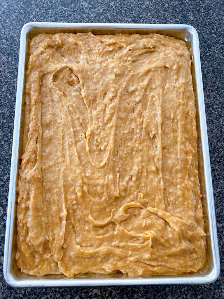 A jelly roll pan filled with pumpkin par batter.