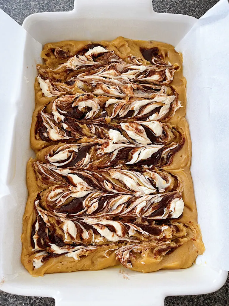 A pan of unbaked cinnamon roll blondies.