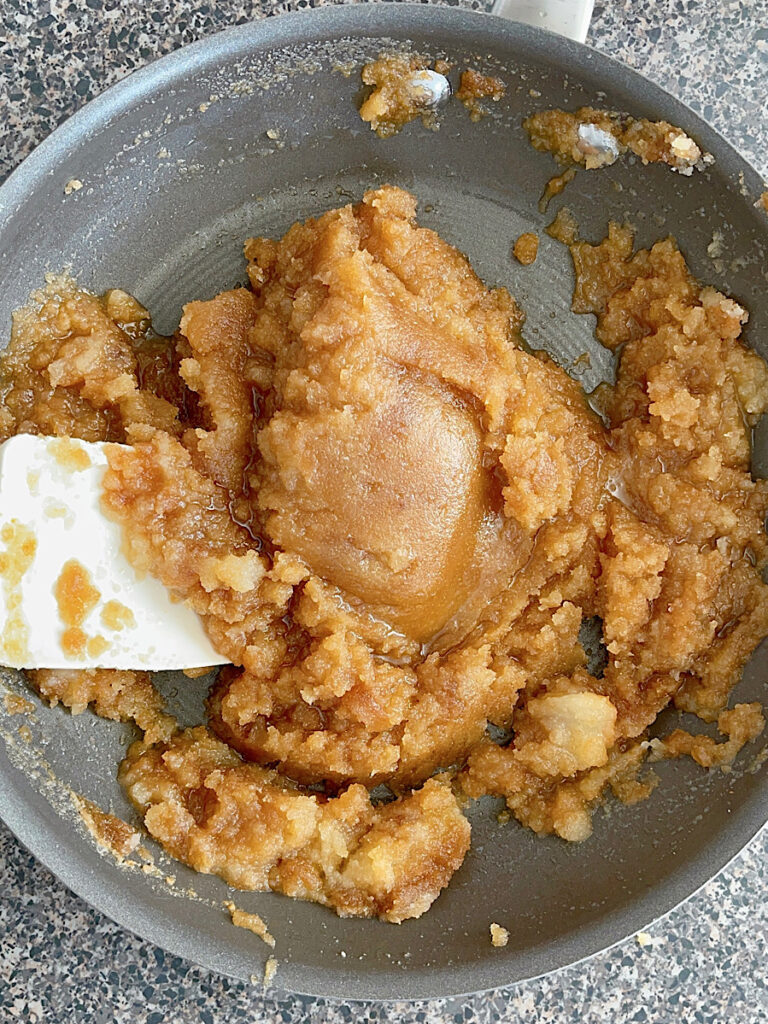 Browned butter mixed with sugar and brown sugar in a pan.