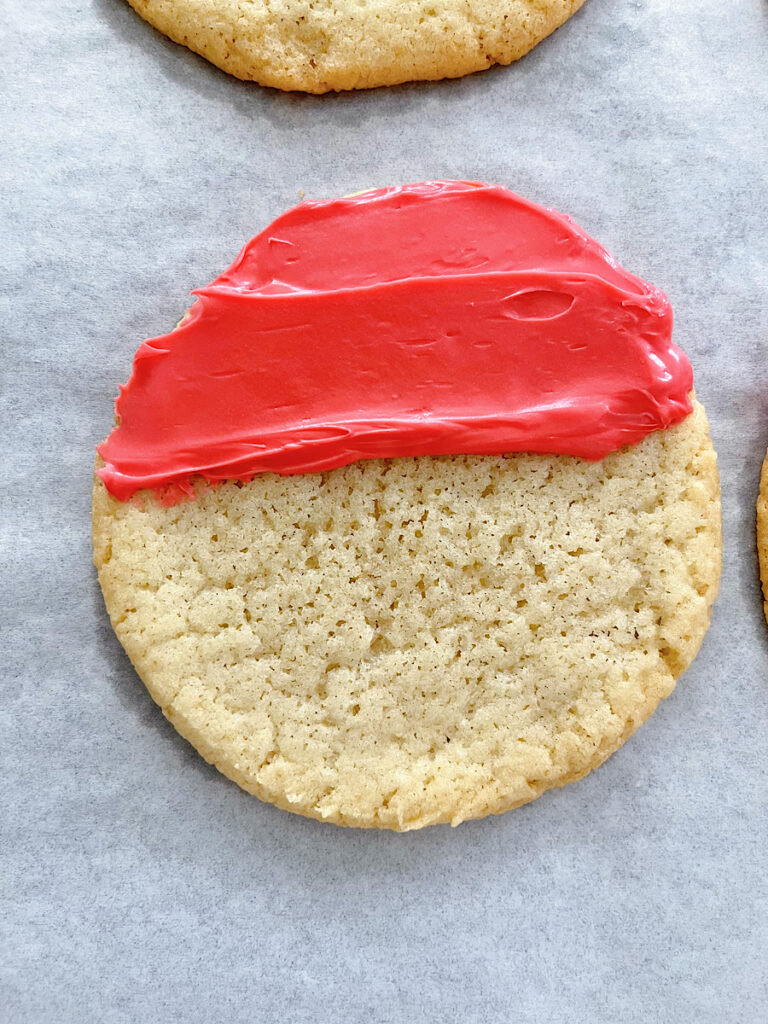 A sugar cookie with red frosting.