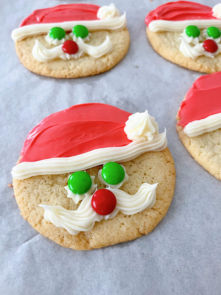A Sugar cookie with red and white frosting to make Santa cookies.