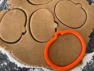 Pumpkin spice sugar cookies cut into pumpkin shapes.