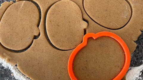 Pumpkin spice sugar cookies cut into pumpkin shapes.