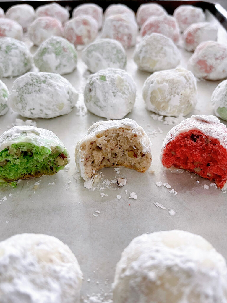 A red, green, and white snowball cookie cut in half.
