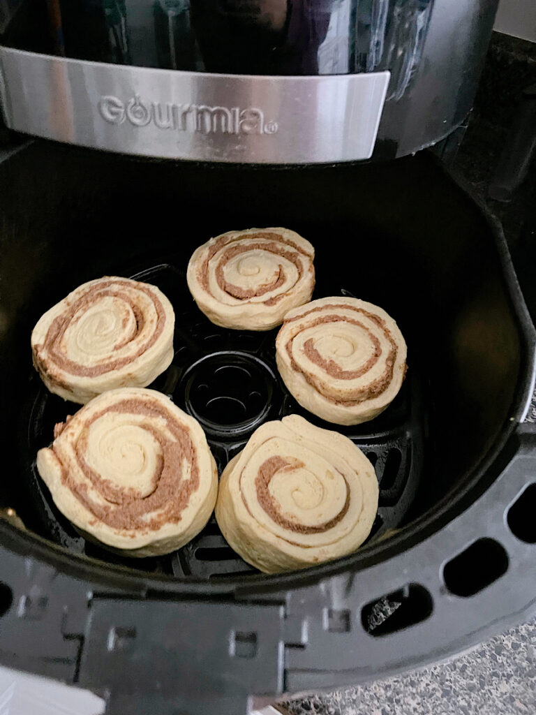 Pillsbury cinnamon roll dough in an air fryer.