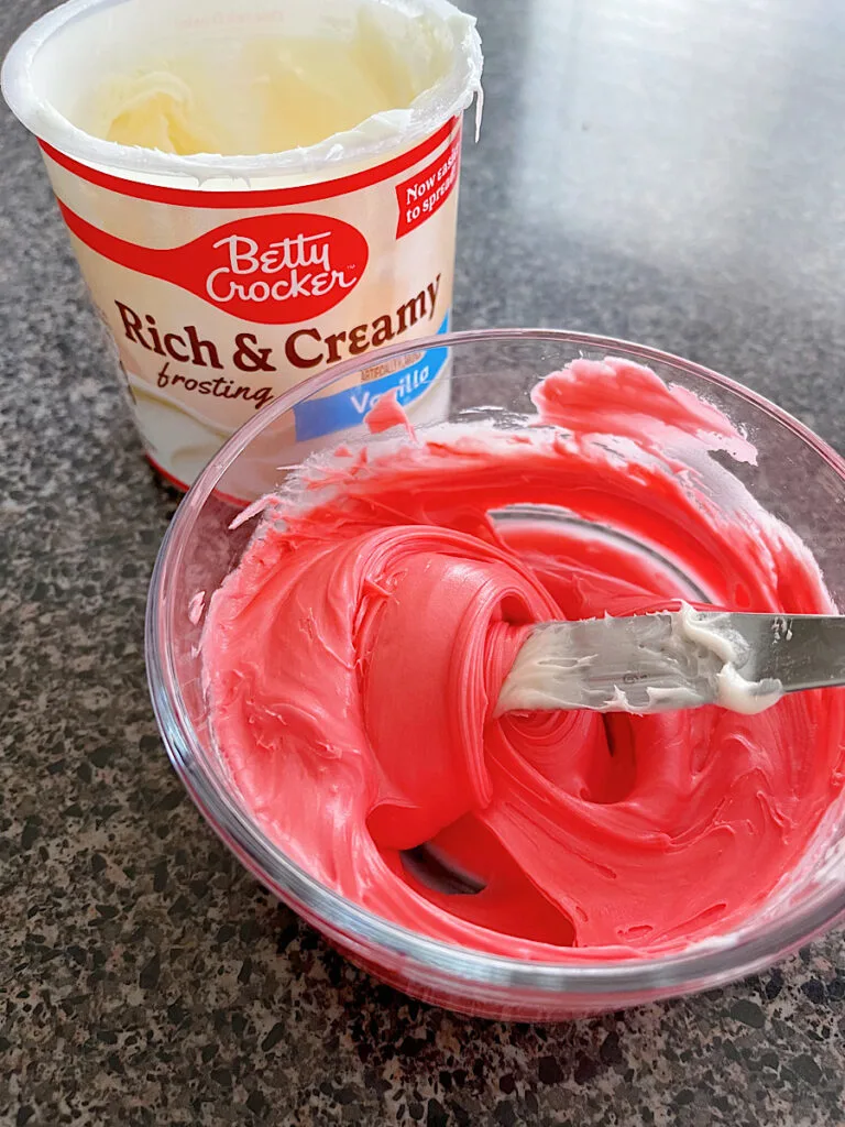 A bowl of vanilla frosting tinted red.