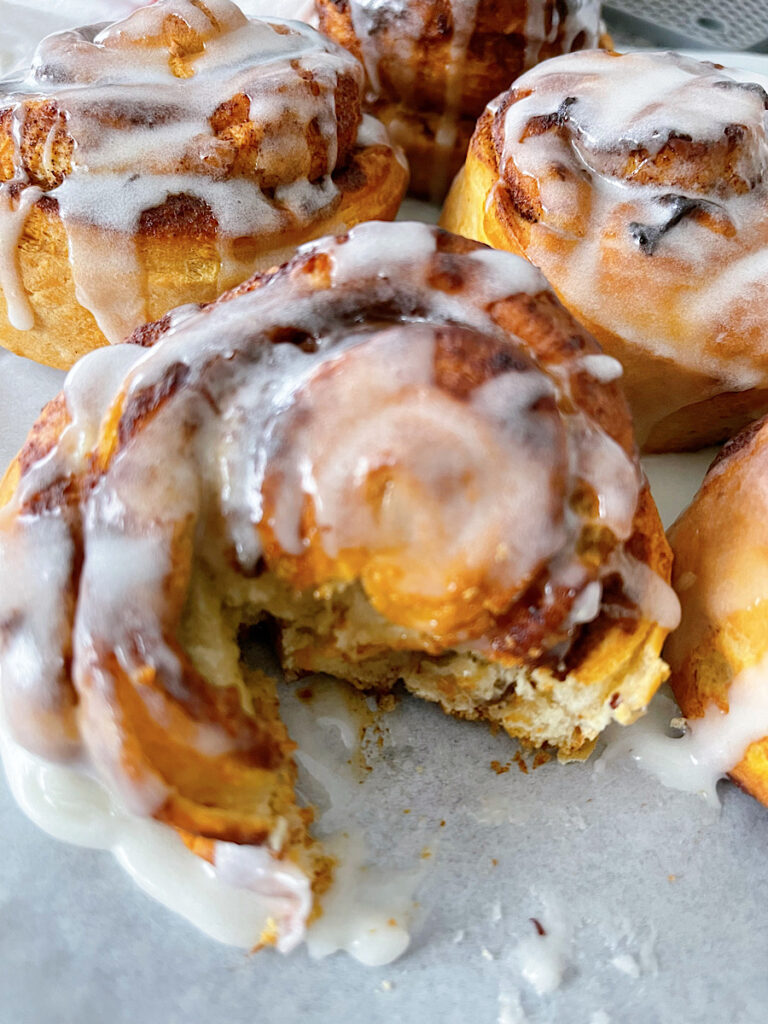 Pillsbury air fryer cinnamon rolls drizzled with icing.