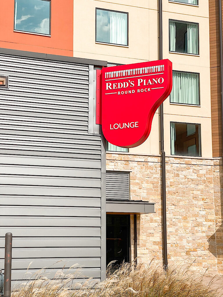 A bar that features live piano music and singing.