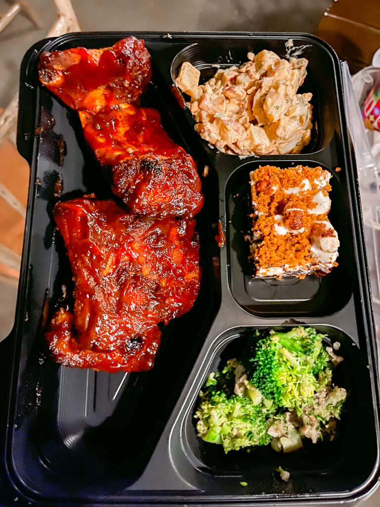 BBQ Ribs from Hungry Bear Restaurant Fantasmic Dining Package with a side of Bacon Potato Salad, Broccoli, and a S'more's dessert.