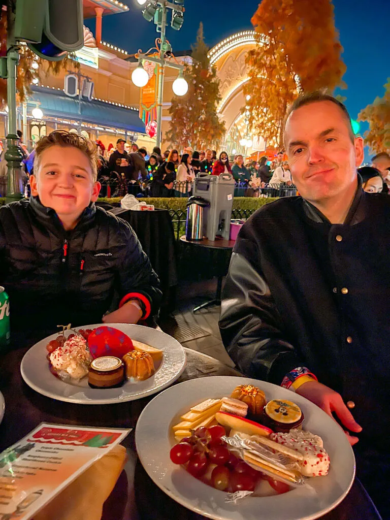 Two guests at a table for the World of Color Dessert Party.