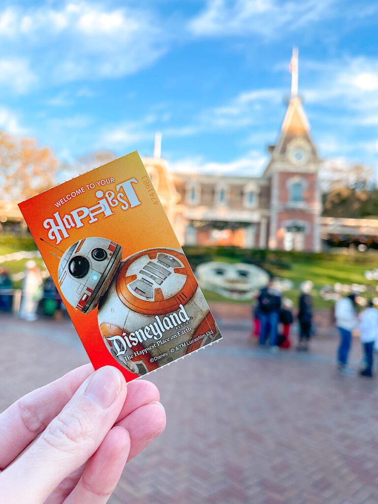 A Disneyland ticket in front of the Disneyland train station.