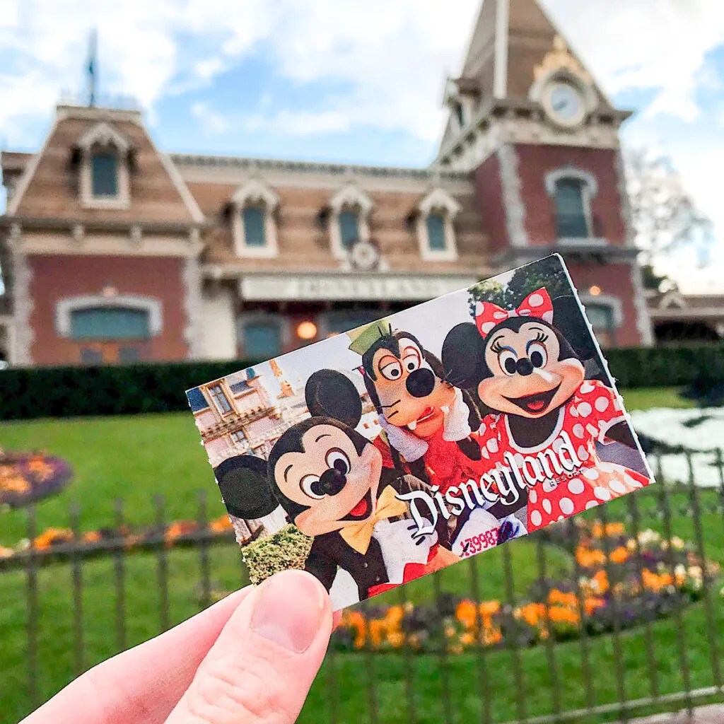 A Disneyland ticket in front of the Disneyland Main Street train station.